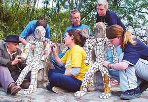 Members of the Nek Chand Foundation, Britain, and the creator of Rock Garden, Nek Chand, remove graffiti from the sculptures. 