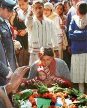 The wife of Flt-Lt Bharat Kumar, along with her son, pays last respects to her husband at the cremation ground in Mani Majra, Chandigarh, on Monday. 