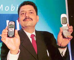 Mr Himanshu Kapania, CEO (Punjab, Haryana, Himachal), Reliance Infocomm, displays mobile sets at a press conference in Chandigarh on Monday.