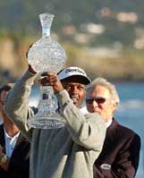 Vijay Singh holds up the trophy beside actor Clint Eastwood 