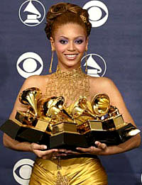 Singer Beyonce holds the five Grammy awards she won at the 46th annual Grammy Awards in Los Angeles 