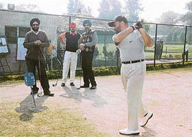 Lt-Gen Joginder Jaswant Singh practices his swing before executing the shot at the Chandigarh Golf Club