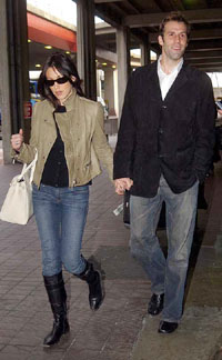 British tennis player Greg Rusedski, accompanied by his wife Lucy, arrives at London's Heathrow airport 