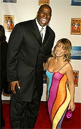Basketball legend Earvin "Magic" Johnson poses with singer and former Los Angeles Laker cheerleader Paula Abdul