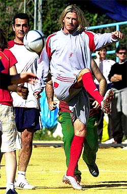Real Madrid's English soccer star David Beckham kicks the ball during the recording of a sports clothes commercial in Gerena