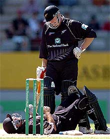 New Zealand�s Craig McMillan lies on the ground after being hit by a ball from team-mate Scott Styris who stands over him
