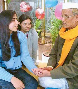 A young visitor gets her palm read by Pt Keshavanand at Hotel Maya Palace