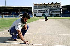 Pakistani workers renovate the National Stadium for the upcoming tour of India in Karachi 