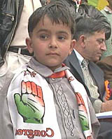 A child adorns a scarf bearing the Congress symbol during a recent rally in Hamirpur. 