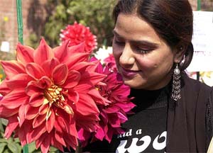 A lady admires a flower