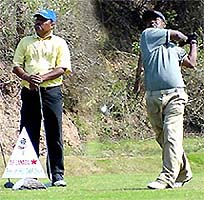 Vijay Kumar watches as Yusuf Ali executes a swing
