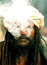 An Indian sadhu smokes marijuana at Pashupati temple in Kathmanadu on Sunday
