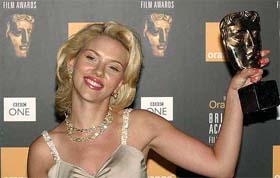 American actress Scarlett Johansson shows her best actress award for her role in �Lost in Translation� at the British Academy Film Awards ceremony in London