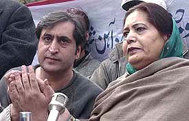 Sajjad Lone, Chairman of the Jammu Kashmir People�s Conference, holds his mother�s hand during a Press conference in Srinagar