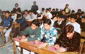 Students of Kamla Lohtia Sanatan Dharam College take part in written quiz competition held at the college