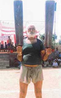 Channan Singh with his mallets at a rural sports festival 