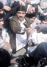 Activists of Delhi Pradesh Youth Congress polishing shoes to demonstrate the plight of unemployed youths at Connaught Place in the Capital on Tuesday.