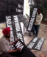 Painters give final touches to sign boards for the cricket match to be organised as part of the Patiala Heritage Festival