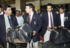An official speaks to members of the Indian golf team after their arrival at Karachi airport 