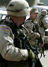 US troops and Iraqi members of ICDC patrol the streets of Baghdad 