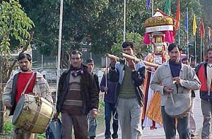 Devotees carry a palanquin of a deity to Mandi in Himachal Pradesh on the occasion of the historical Shivratri Fair on Tuesday.