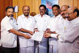 aiadmk and BJP leaders show the poll accord signed by them
