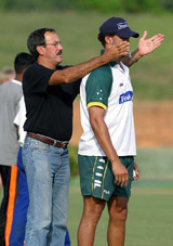 Former Australian spinner Bruce Yardley passes on a tip to Australian player Andrew Symonds during a practice session in Dambulla, Sri Lanka