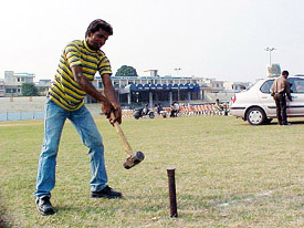 Workers try to erect barricades for the Punjabi Music Awards show at the Guru Gobind Singh Stadium