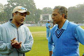 Pakistan's veteran cricketers team captain Ijaz Ahmed talks with his Indian counterpart Mohinder Amarnath at the start of play in Patiala