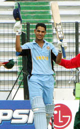 Indian batsman Shikhar Dhawan waves for spectators after scoring a century against Bangladesh in the under-19 cricket World Cup match