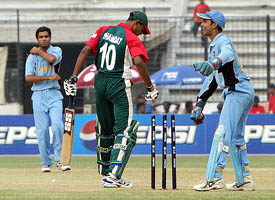 Indian wicketkeeper Dinesh Kartick cheers after stumping Bangladesh's last batsman Shahadat as bowler Abhishek Sharma  looks on 