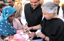 JUST TWO DROPS: Delhi Chief Minister Sheila Dikshit with Minister of Health Yoganand Shastri administering pulse polio drops to a child during the formal launch of the campaign at her residence in the Capital on Saturday.