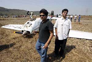 Flight trainer Divya Sangvi (left), and trainee Chirag Thakkar walk past a Cessna 152 which crashlanded