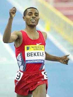 Ethiopia's Kenenisa Bekele crosses the line after breaking the world indoor record for the 5000 metres at Birmingham's Indoor Arena