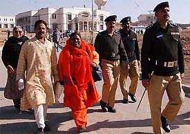 Pilgrims from India are escorted by security personnel after their visit to the Katasraj temple in Pakistan