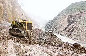 A worker widens the Srinagar-Muzaffarabad road near Uroosa, 117 km north of Srinagar