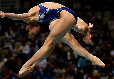 Minxia Wu and Jingjing Guo from China perform a dive in women's synchronised 3m springboard finals during the last day of the 14th FINA Diving World Cup in Athens' Olympic Aquatic Center