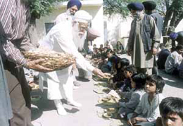 Delhi Sikh Gurdwara Management Committee president Prahlad Singh Chandok distributing �langar� in the Capital.