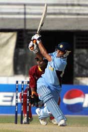 Indian batsman Suresh Raina hits a ball off Rishi Bachan of the West Indies during a super league match of the ICC Under-19 Cricket World Cup