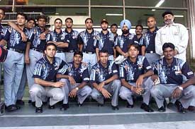 Members of the Indian hockey team pose for a group photograph at IGI airport in New Delhi 