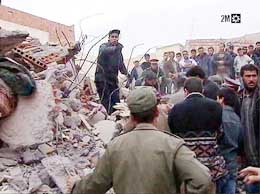 A frame grab taken from Moroccan 2M television footage shows men clearing rubble with their bare hands following an earthquake in the town of Al Hoceima on Tuesday