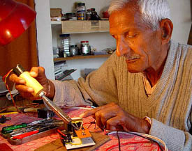 Mr H.R. Mittal gives finishing touches to his "load limiting device"