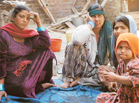 Mourning family members of a youth, Jyoti, who was allegedly murdered