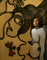 A visitor is reflected in the glass