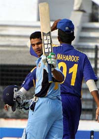 Indian batsman Shikhar Dhawan waves to spectators after reaching his century against Sri Lanka 