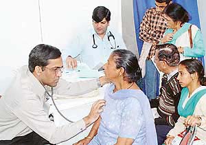 A heart specialist examines a patient at a medical camp in the Mansa Devi temple, near Panchkula, on Friday. 