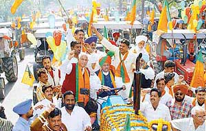 Mr Satya Pal Jain drives a tractor at a rally of the BJP in front of the party office in Sector 33, Chandigarh, 