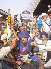 Farmers sit on a dharna on the railway tracks in Patiala on Saturday.
