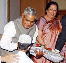 Prime Minister Atal Bihari Vajpayee receives a bouquet from a child of Khalidmul Islam Madarsa before the release of Devnagri transcription of Maulana Abul Kalam Azad’s ‘Tarjumanul Quran’, in New Delhi on Saturday.