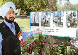 Mr H.S. Dhaliwal, Executive Engineer, Horticulture, PUDA, shows photographs at an exhibition during the Mohali Flower Show.